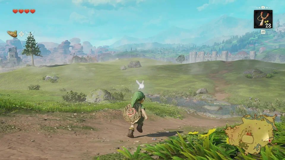 Link running across grassy Hyrule Field with a stream beside the path, the Castle Town wall on the right, and red rock mesas in the distance on the left
