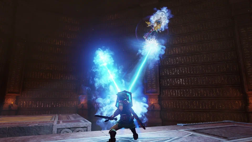 Adult Link with shield raised as a blue ice beam bounces off it in a sharp V and streaks back up toward Kotake on her broomstick, in a stone arena whose walls are covered floor to ceiling in glyphs
